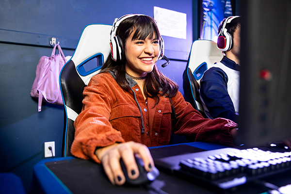 A female gamer wearing a headset participating in a tournament