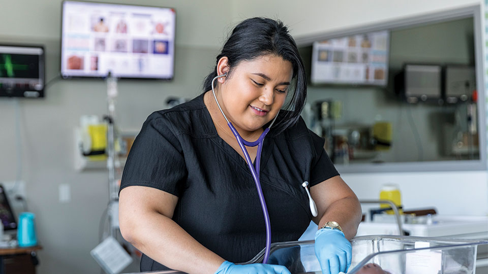 A practical nursing student participating in a simulation