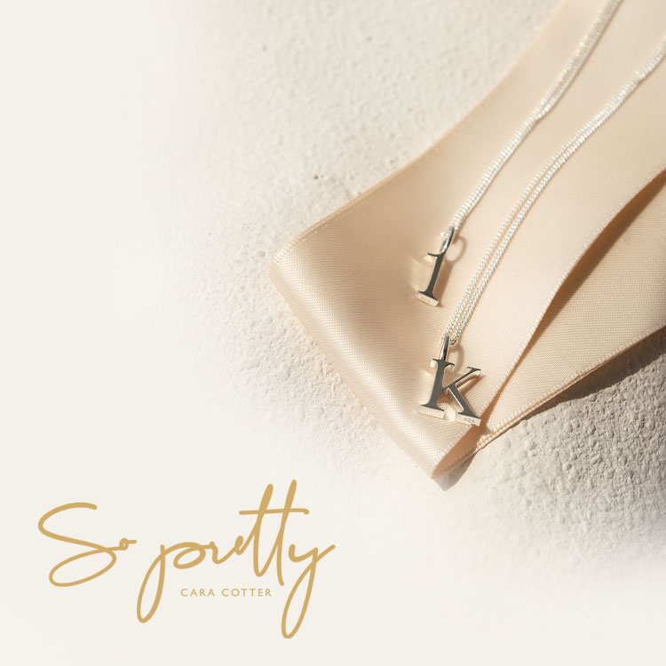 A necklace with a 1 and K charm on it