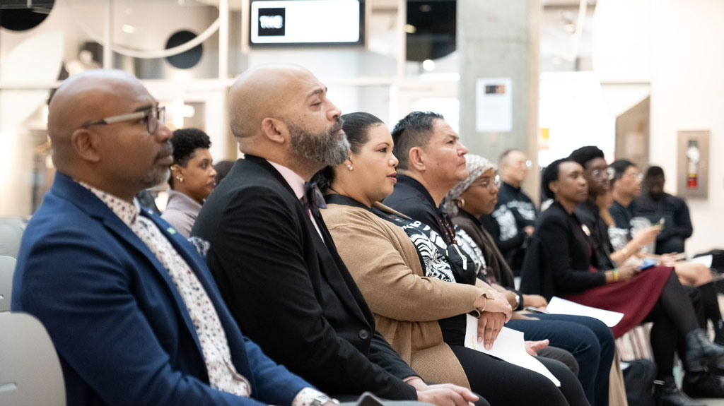 A group of people on a stage having a discussion