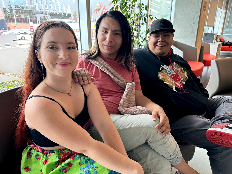 Three people sitting on a couch in the Indigenous Student Centre