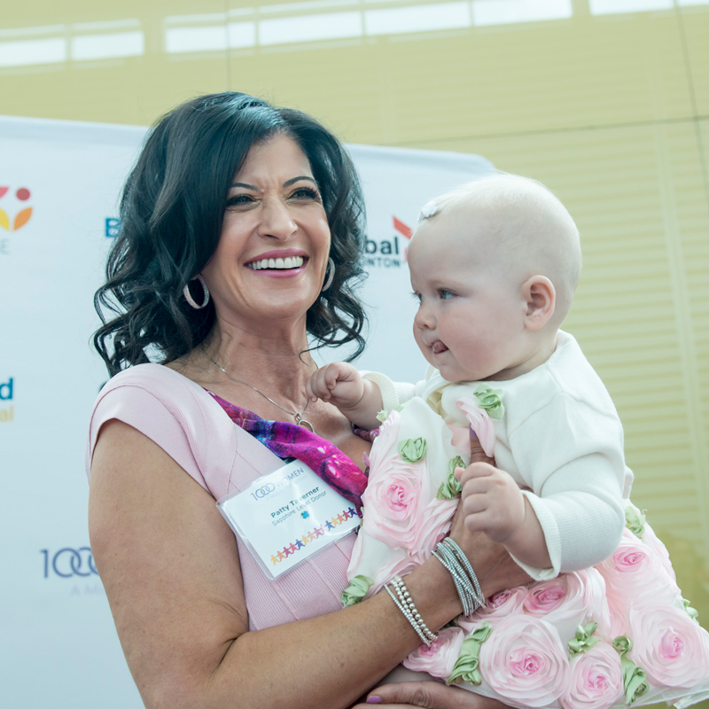 A women holding a baby at a fundraising event