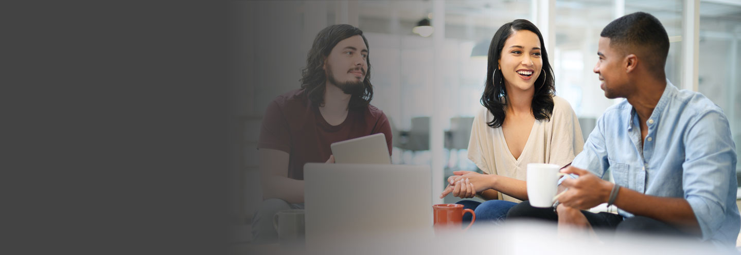 Three people enjoying having a work discussion