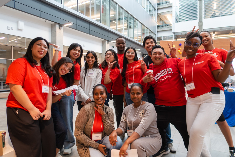 A group of NorQuest International students in the Atrium posing for a group photo