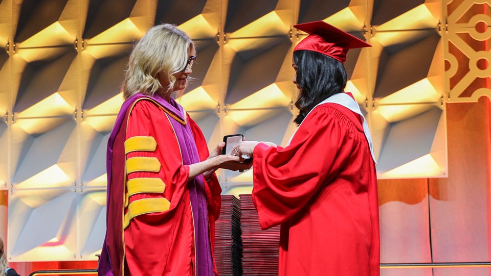 Rhecy Reyes receiving her Presidents Medal from Carolyn Campbell 