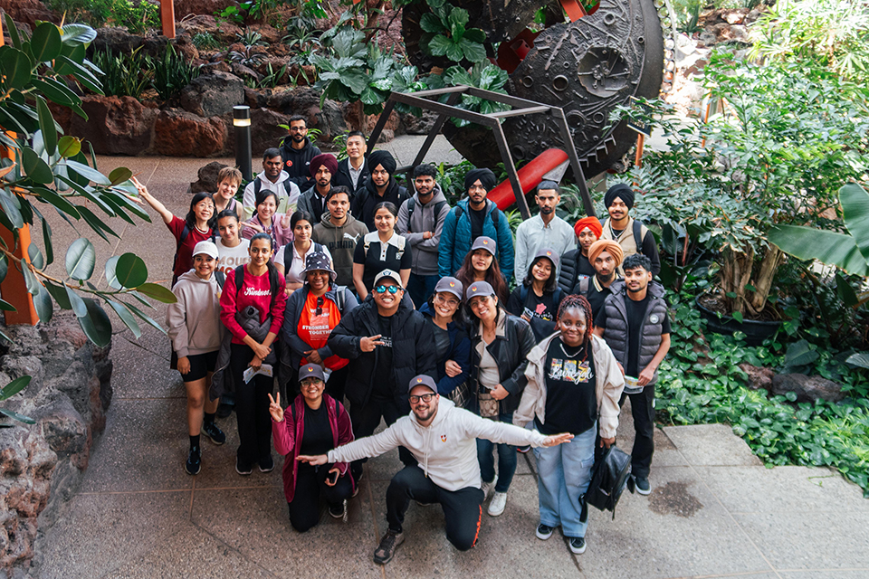International students posing for a group photo and an event off campus